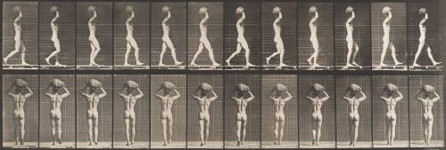 Walking and Carrying a 75-lb Stone on Head, Hands Raised