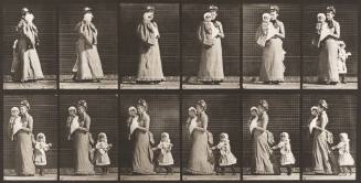 Walking, Carrying a Child, Turning Around; Another Child Holding onto the Woman's Dress