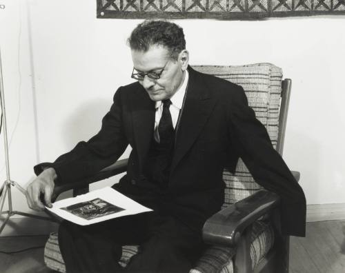 Jose Clemente Orozco with a Print of One of His Paintings