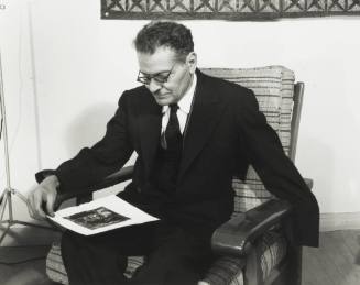 Jose Clemente Orozco with a Print of One of His Paintings