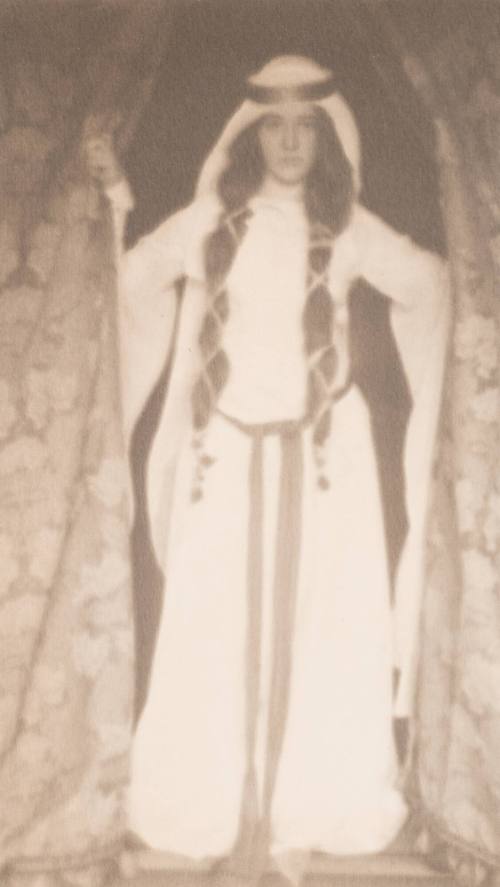 Woman in Medieval Costume Standing Between Curtains