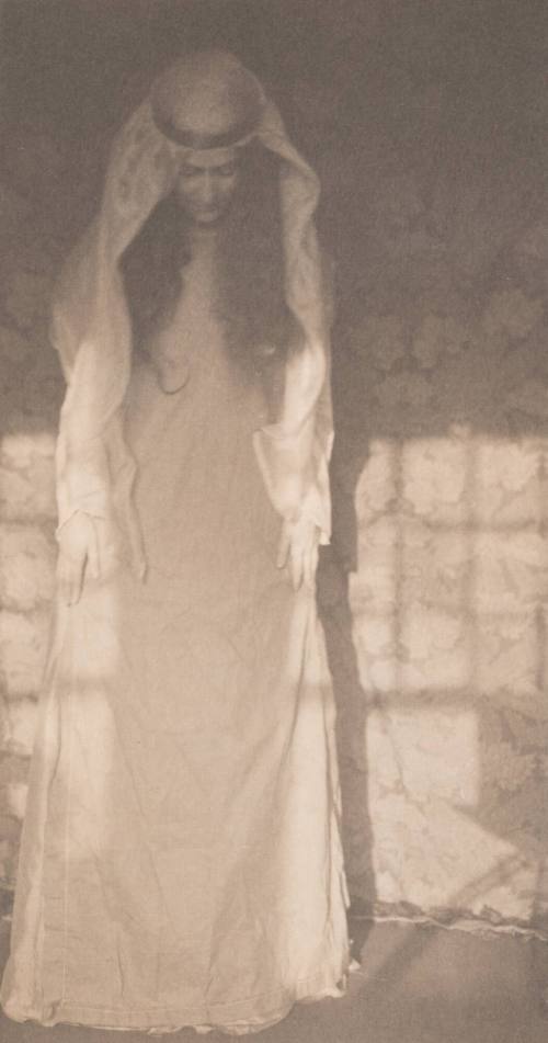 Woman in Medieval Costume Standing With Head Bowed