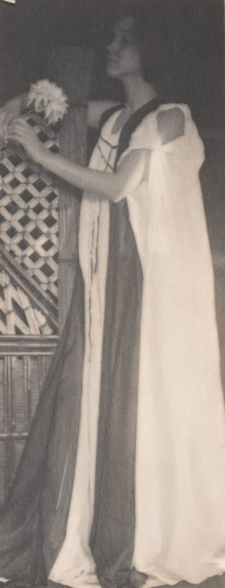 Standing Woman in Medieval Costume Leaning Against Lattice Work, Holding Chrysanthemum