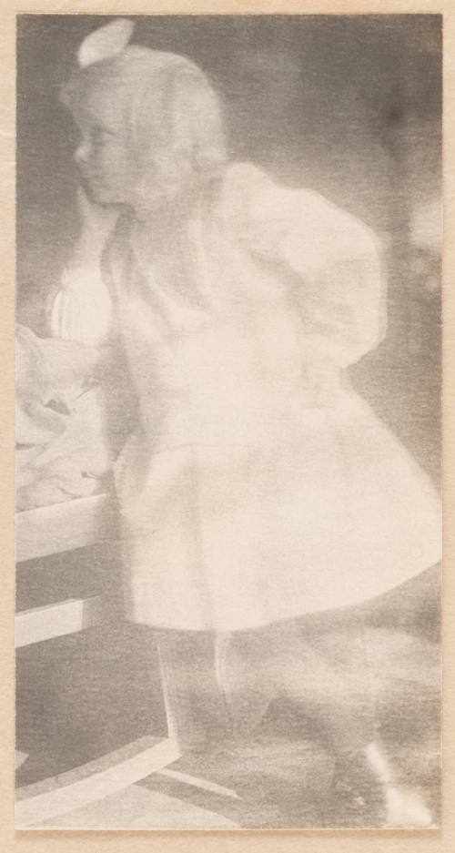 Young Girl Standing With Chin Resting on Right Hand