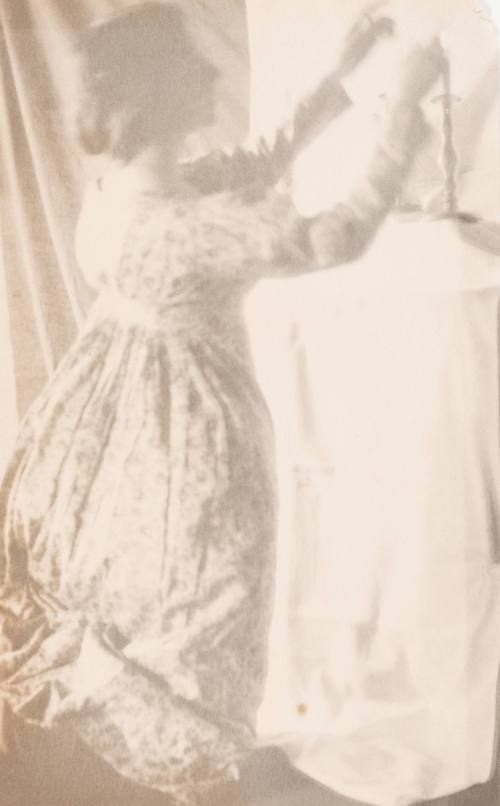 Kneeling Woman Lighting Candle