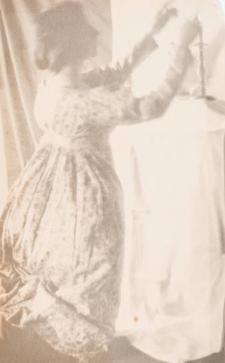 Kneeling Woman Lighting Candle