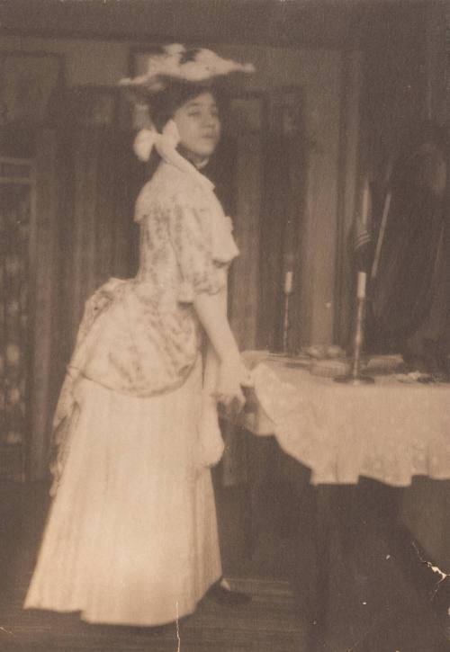 Young Woman in 18th Century Period Dress Opening Table Drawer