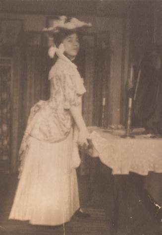 Young Woman in 18th Century Period Dress Opening Table Drawer