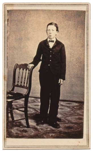 Boy with Right Hand on Chair