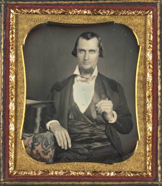 Seated Man with Top Hat on Table