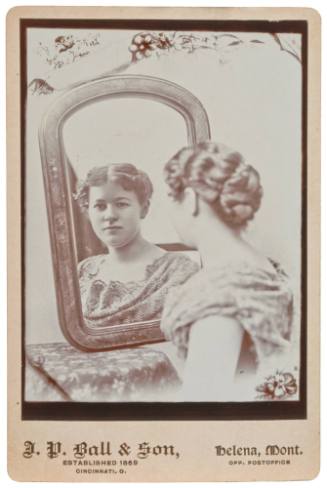 Woman Looking at Herself in a Mirror.
