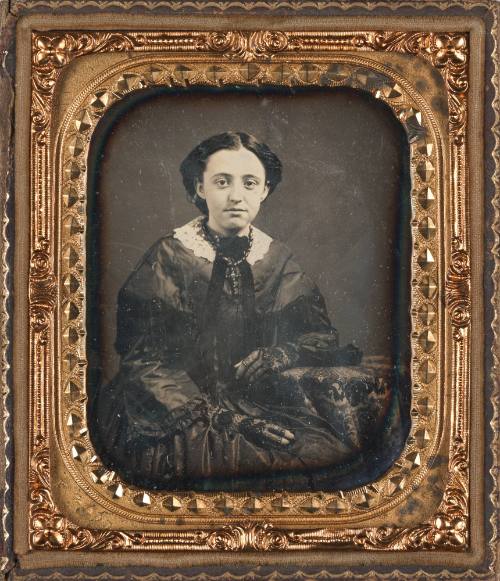 Seated Woman Wearing Gloves