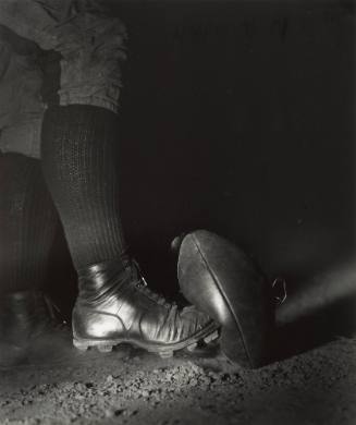 Wes Fesler Kicking a Football