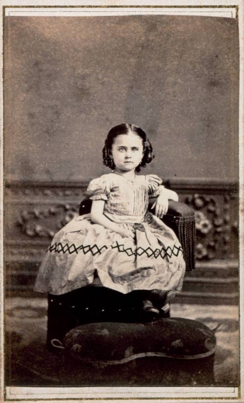 Seated Girl with Diamond Pattern on Skirt